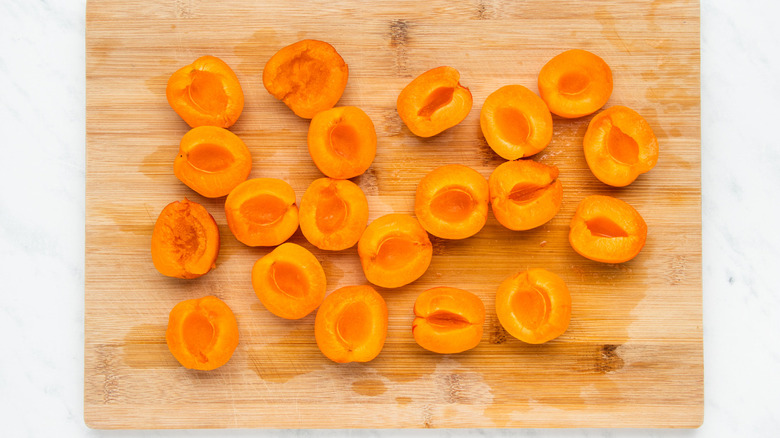 sliced apricots on cutting board