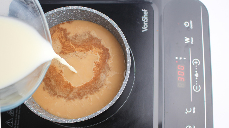 milk pouring into a saucepan