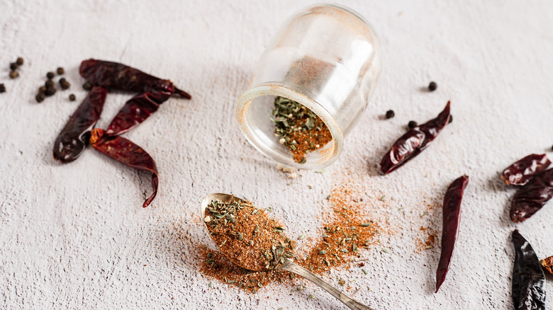 creole seasoning in jar with spices and spoon