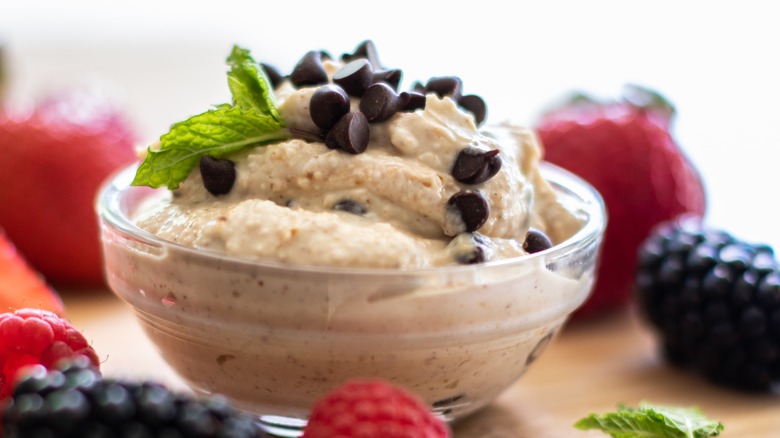 Cookie dough-style dip in glass container with chocolate chips