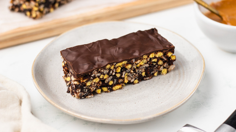 Chocolate peanut butter cereal bar on plate