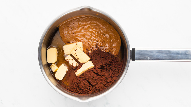 Butter, cocoa powder, and peanut butter in a saucepan