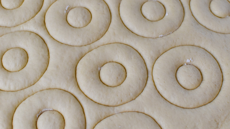 doughnut shapes cut into dough