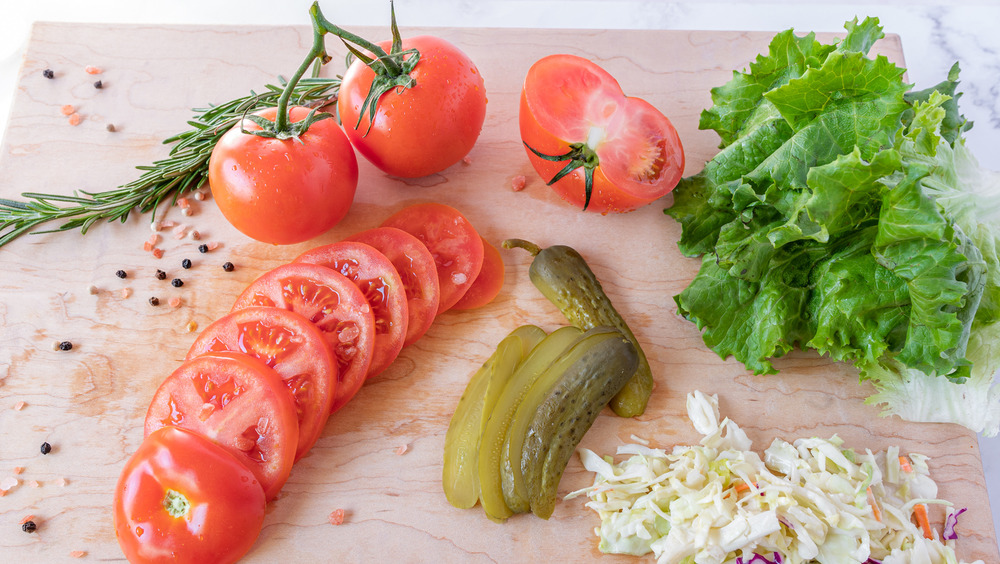 slicing sandwich vegetables for homemade hot pastrami sandwich