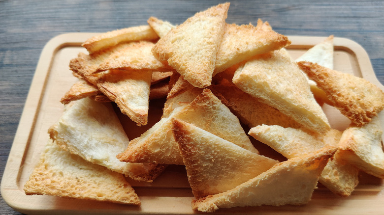 Melba toast on cutting board