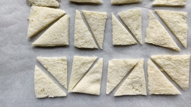 Triangle-sliced bread on baking pan