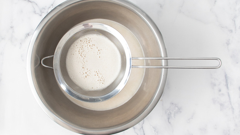 straining homemade oat milk