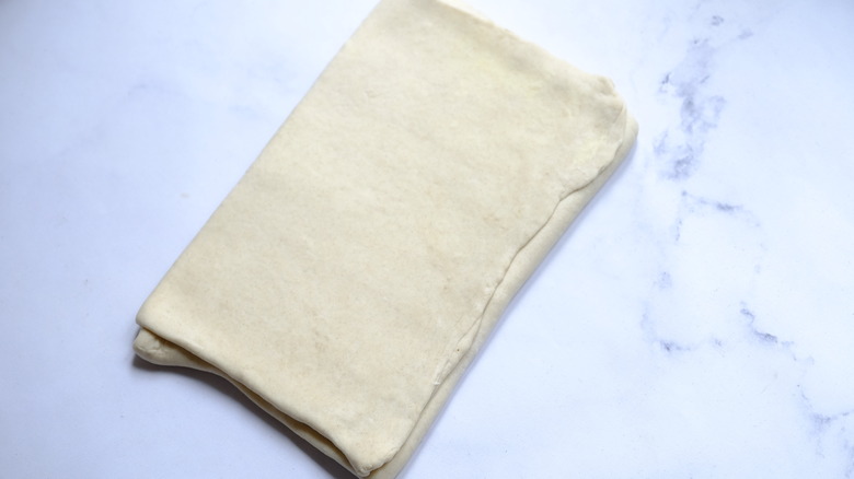 folded and rolled puff pastry dough