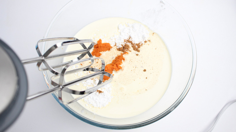 mixing ingredients for pumpkin ice cream