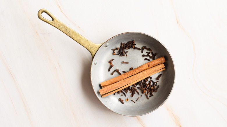 whole cinnamon and cloves in pan