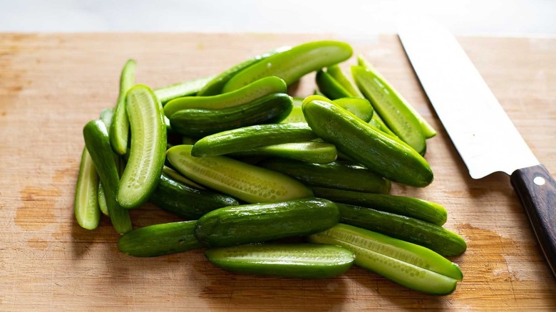 sliced cucumbers with knife