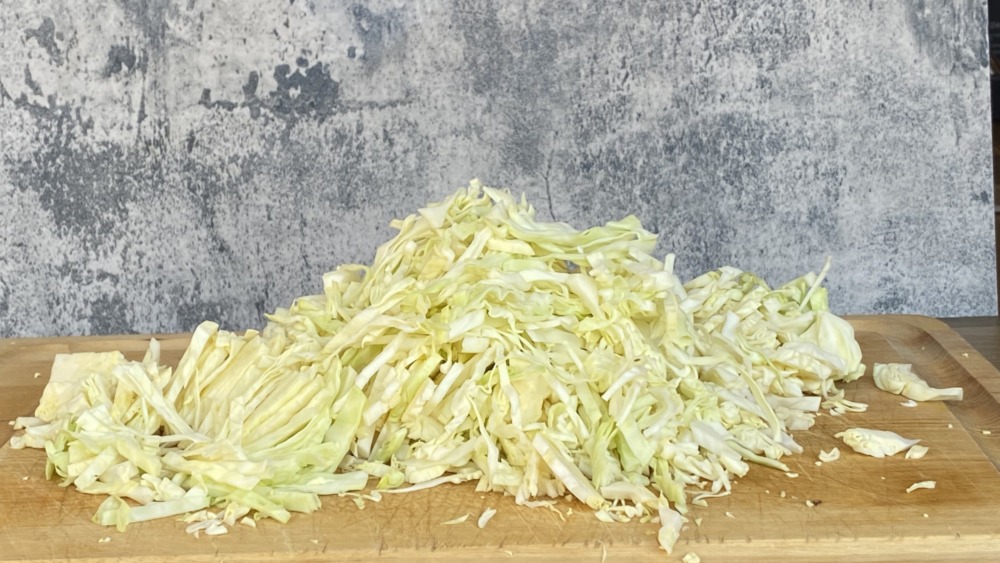 homemade sauerkraut thin sliced on a cutting board