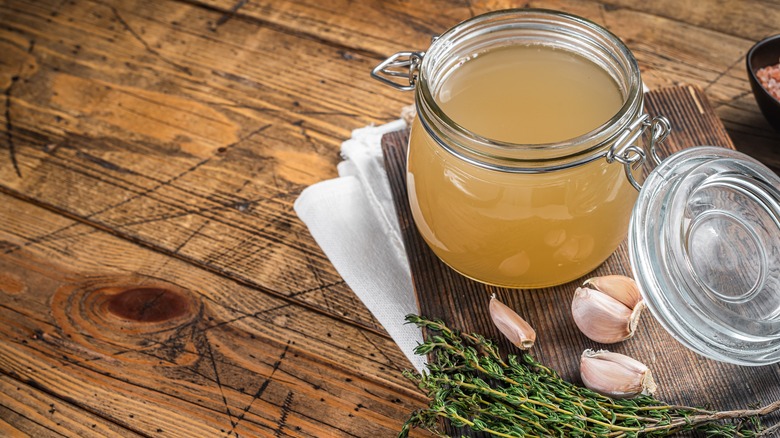 homemade chicken stock in a glass jar