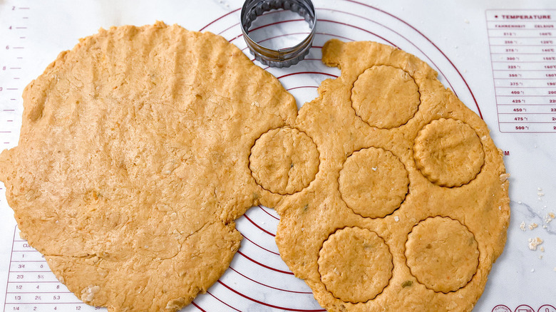 rolled dough with circle cutouts