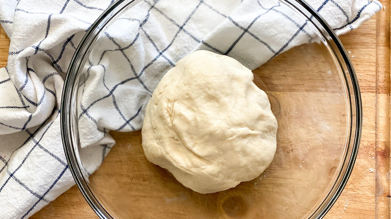 bread dough in glass bowl