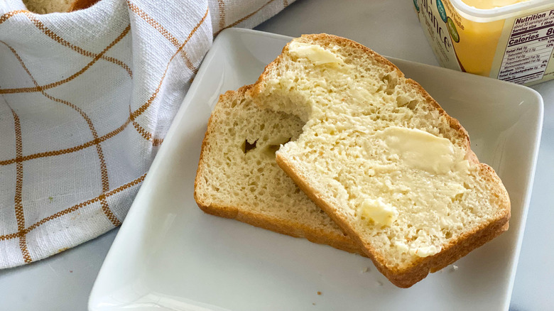 slices of bread on plate with Earth balance margarine