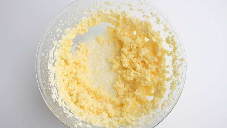 butterfat and buttermilk, separated in a glass bowl