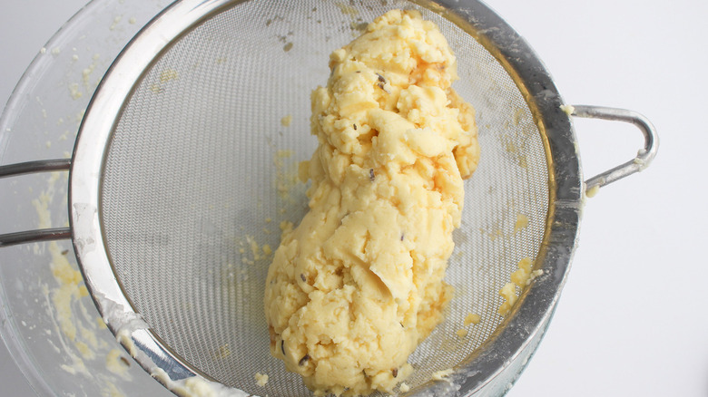 sieved butter in strainer with lavender flecks