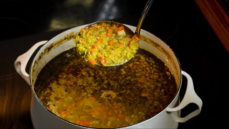 chunky pea soup in ladle