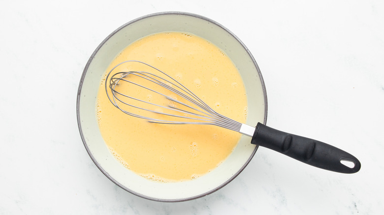 Egg and milk mixture whisked in dish