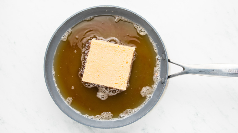 Stuffed French toast frying in pan