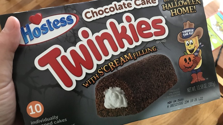 Hand holding box of Halloween-themed Twinkies