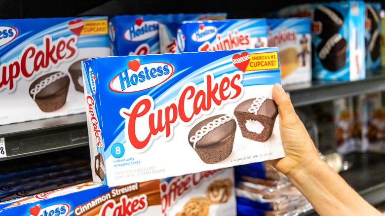 Someone holds a box of Hostess Cup Cakes