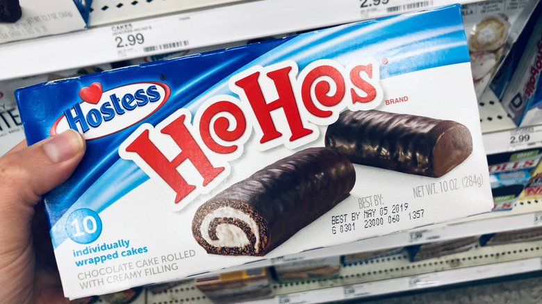 Someone holds a box of Hostess HoHos