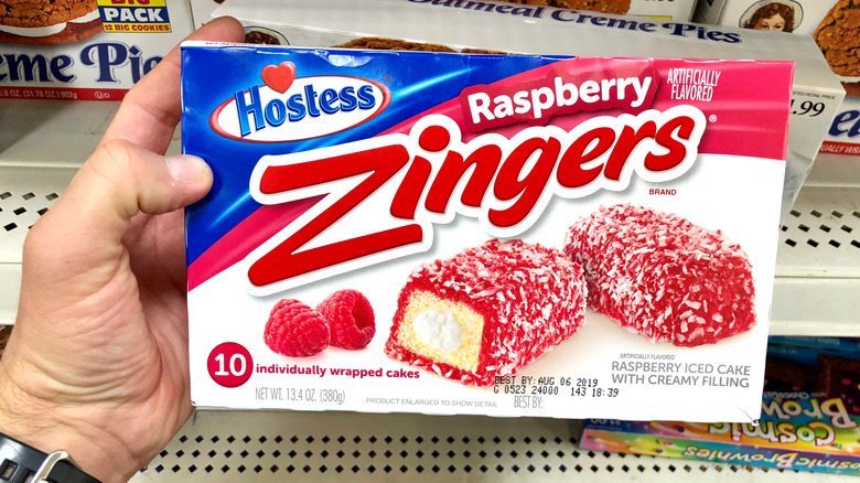 Someone holds a box of Hostess Zingers