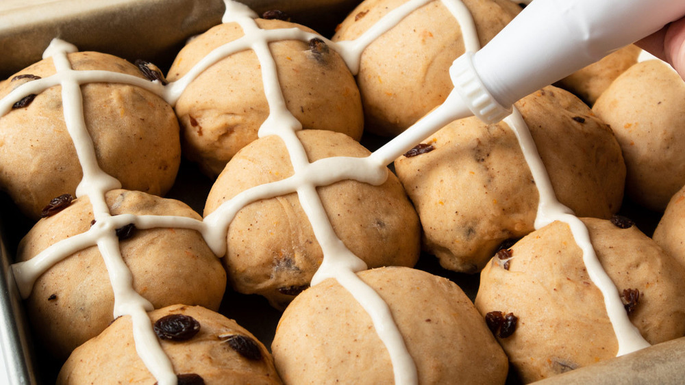 Piping the crosses onto the hot cross buns