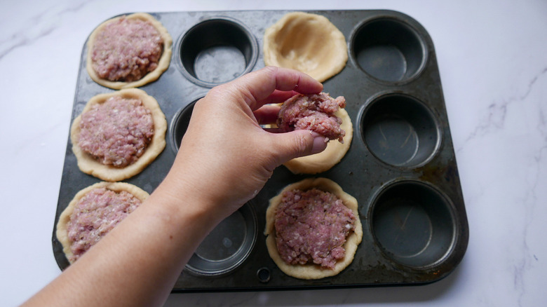 filling in muffin tin 