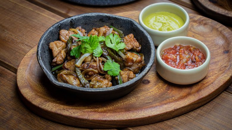 grilled sweetbread on a plate with sauces