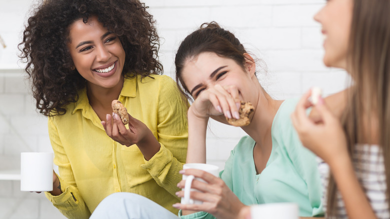 Three women conversing over tea