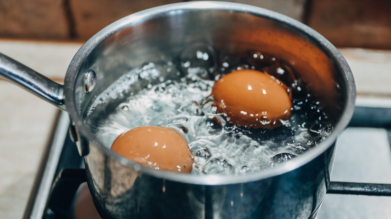 saucepan with boiling eggs