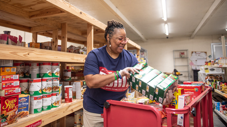 woman taking food from a food bank