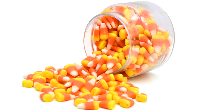 Candy corn spilling from a jar