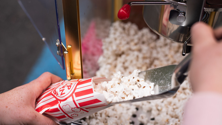 Popcorn being scooped into bag