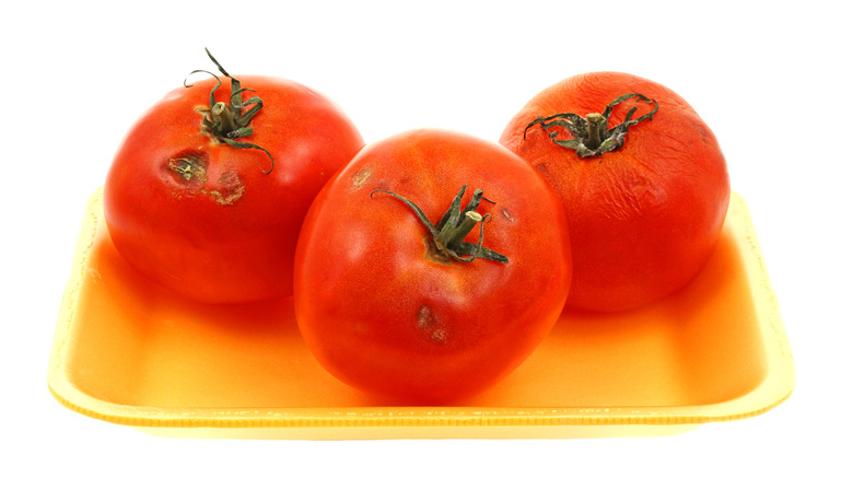 bruised tomatoes on yellow plate