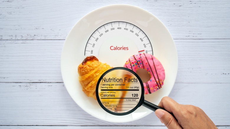 person inspecting donut on plate