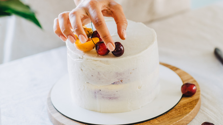 baker decorating cake