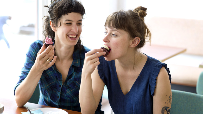 two people eating cake