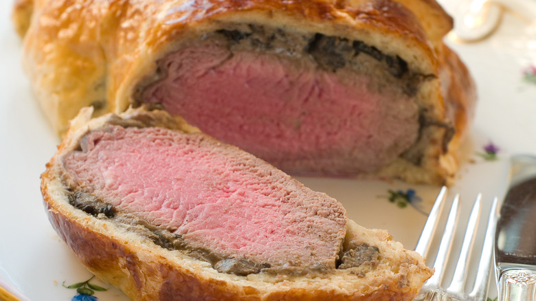 Beef Wellington sliced open to reveal a pink center