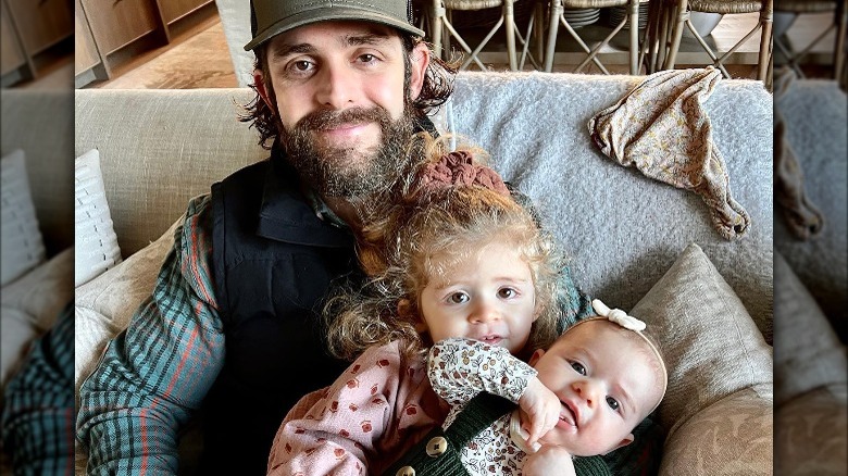 Thomas Rhett sitting with his children