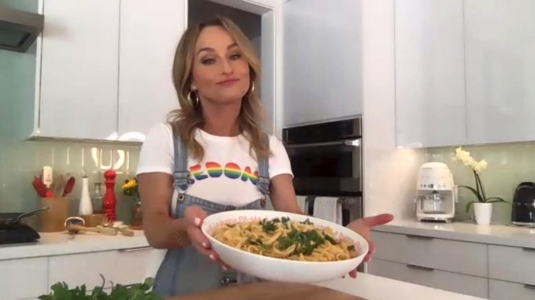 Giada De Laurentiis holding a bowl of pasta up to the camera