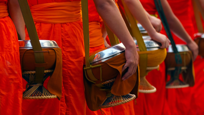 Buddhist monks carrying alms bowls