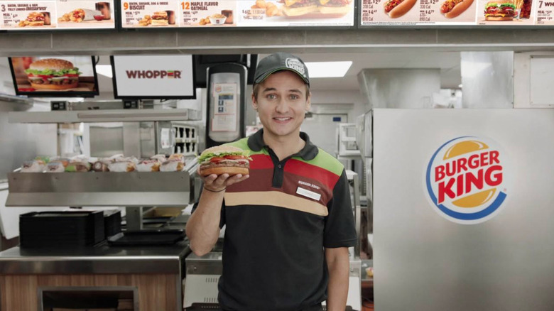 worker in striped Burger King polo