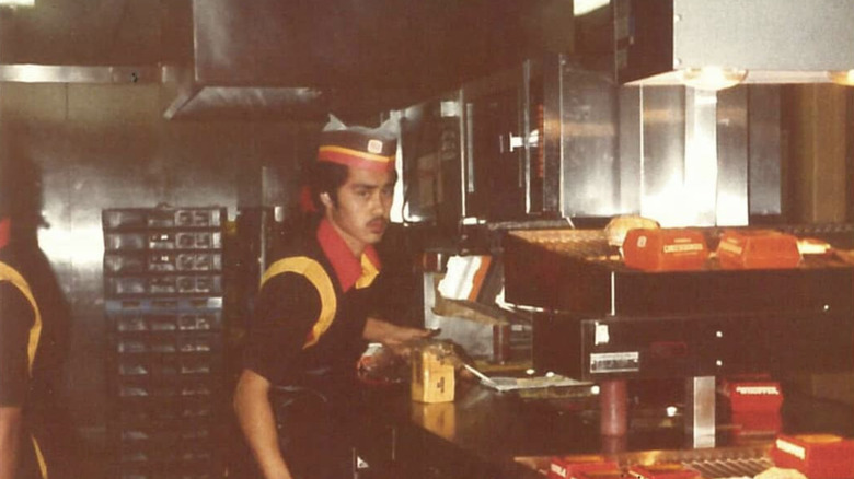 Burger King employee in paper hat