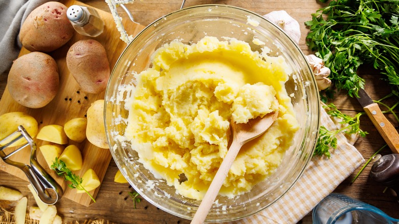 bowl of mashed potatoes surrounded by ingredients