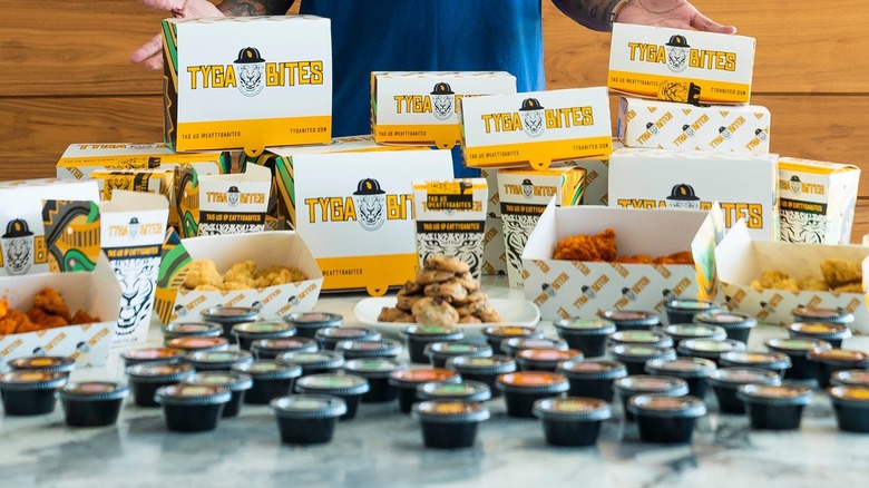 Boxes of Tyga Bites next to rows of sauces