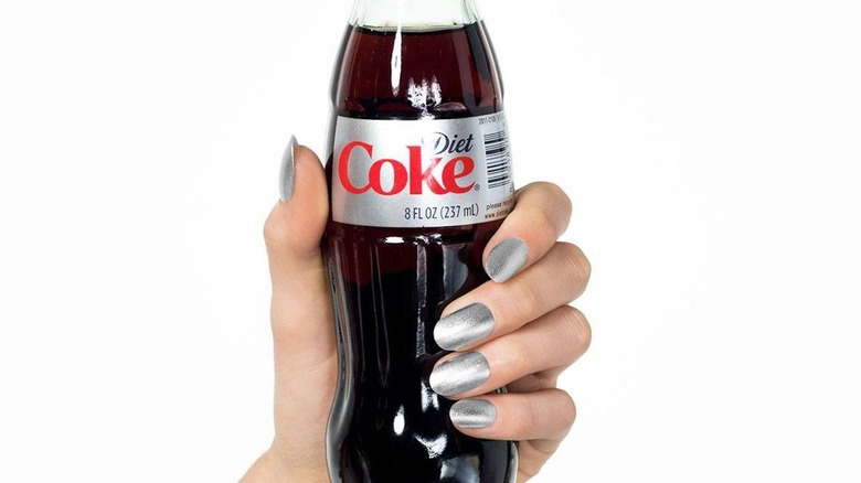 hand holding bottle of Diet Coke